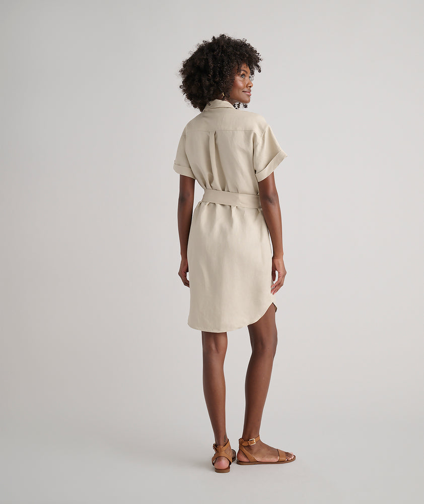 Model is wearing UNTUCKit Betty solid khaki dress. 