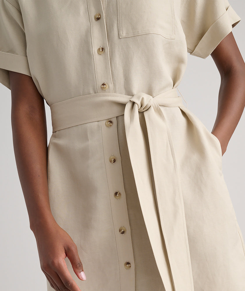 Model is wearing UNTUCKit Betty solid khaki dress. 