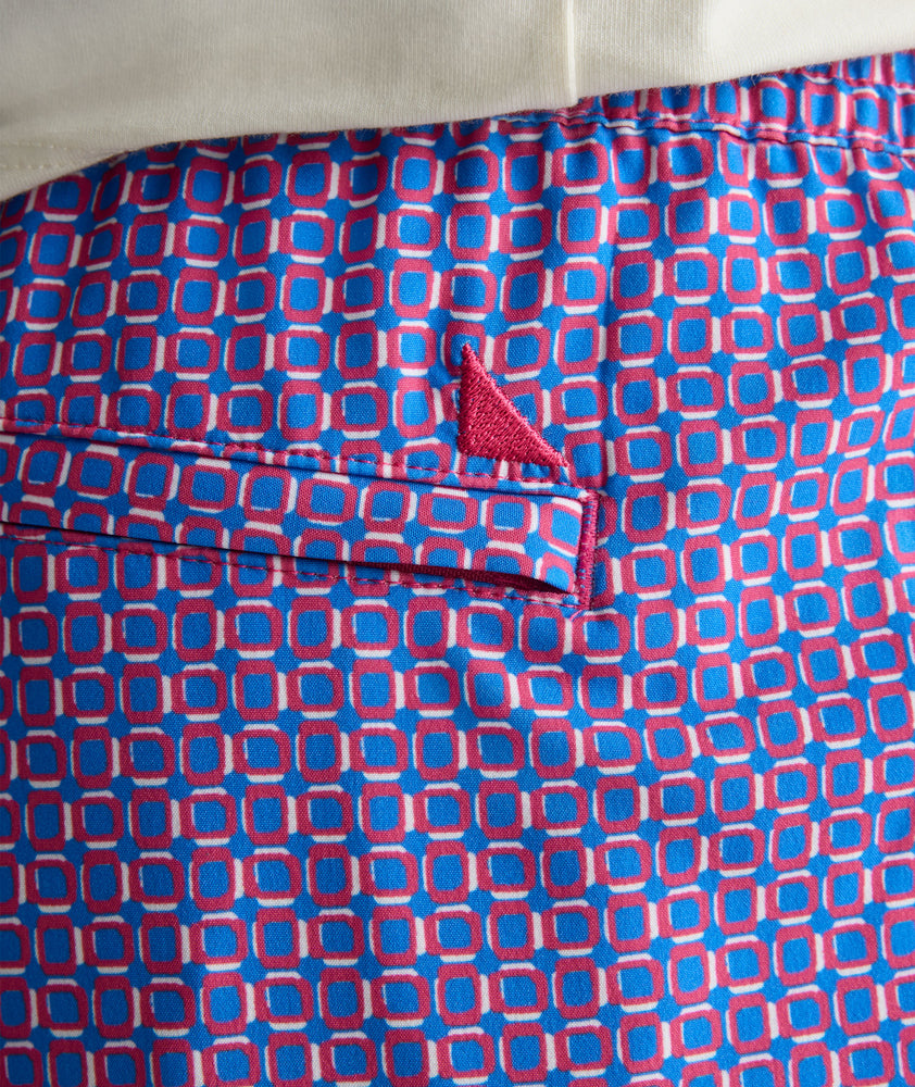 Model is wearing UNTUCKit Beyond Shorts in red and blue. 