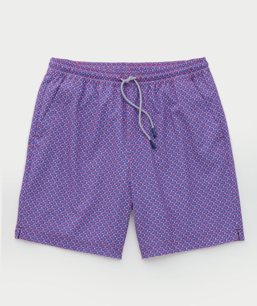 Model is wearing UNTUCKit Beyond Shorts in red and blue. 