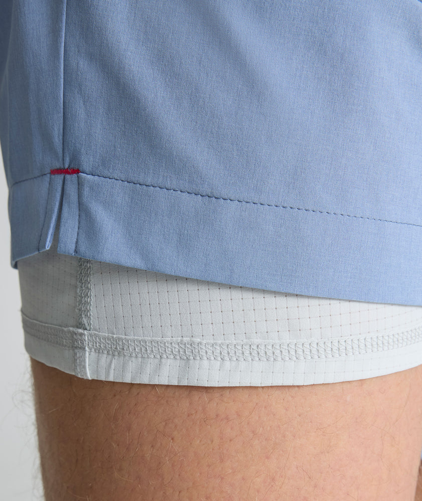 Model is wearing UNTUCKit beyond short in stonewash. 