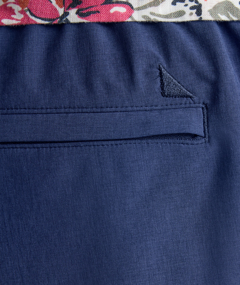 Model is wearing UNTUCKit beyond short in peacoat. 