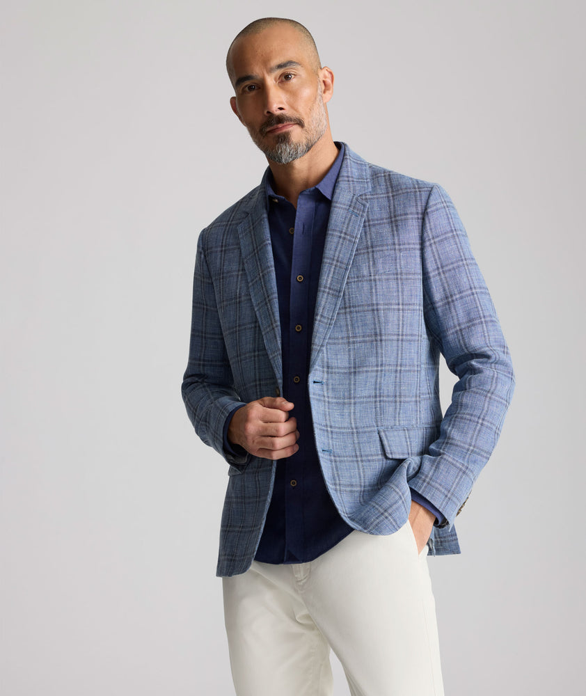 Model is wearing UNTUCKit Linen-Cotton Binkenhall Sport Coat in blue windowpane. 
