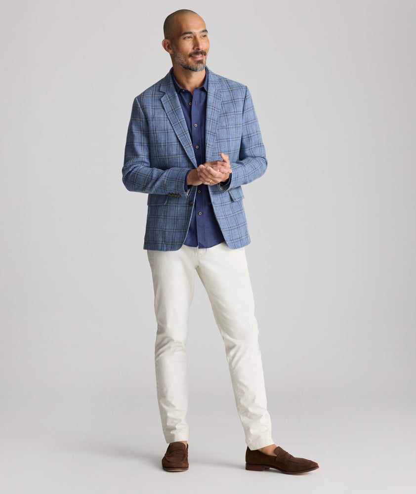 Model is wearing UNTUCKit Linen-Cotton Binkenhall Sport Coat in blue windowpane. 