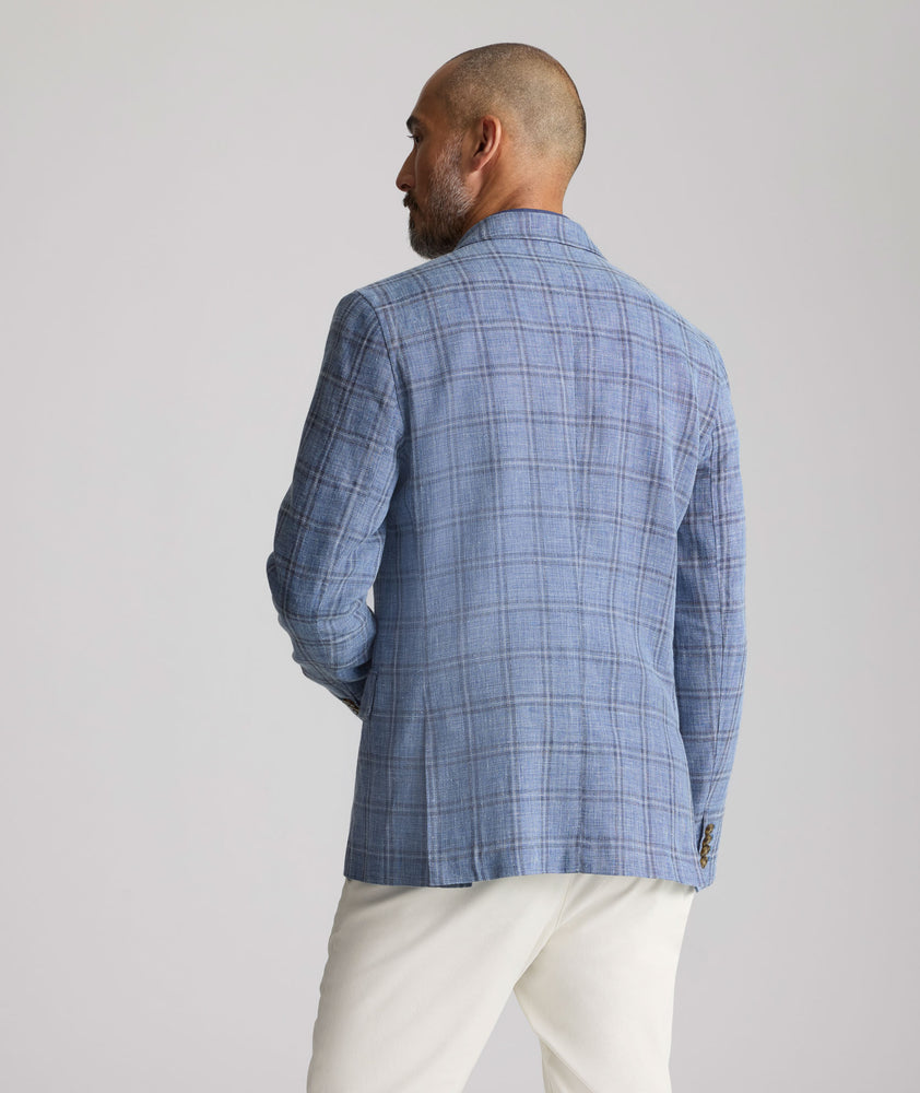 Model is wearing UNTUCKit Linen-Cotton Binkenhall Sport Coat in blue windowpane. 