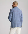 Model is wearing UNTUCKit Linen-Cotton Binkenhall Sport Coat in blue windowpane. 