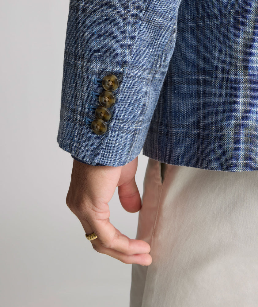 Model is wearing UNTUCKit Linen-Cotton Binkenhall Sport Coat in blue windowpane. 