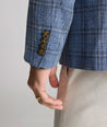 Model is wearing UNTUCKit Linen-Cotton Binkenhall Sport Coat in blue windowpane. 