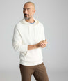 Model is wearing UNTUCKit Waffle-Knit Hoodie Sweater in white. 