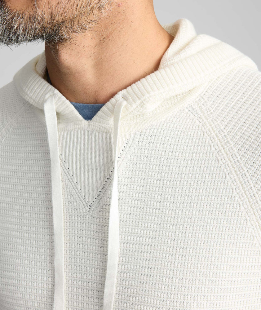Model is wearing UNTUCKit Waffle-Knit Hoodie Sweater in white. 