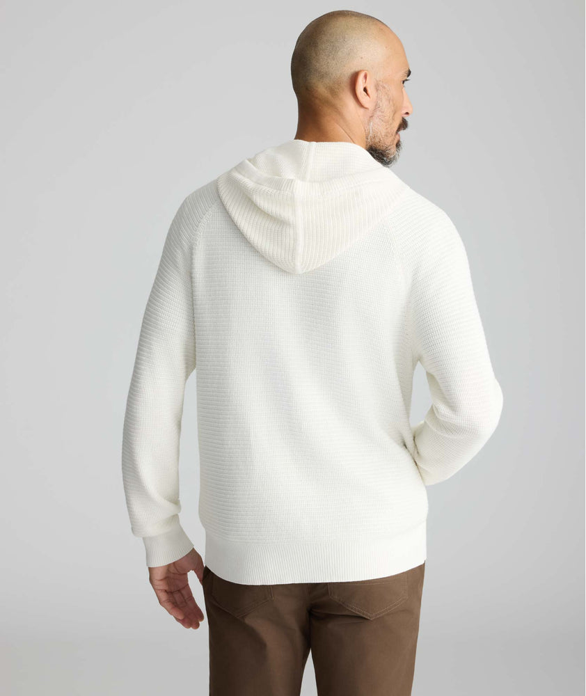 Model is wearing UNTUCKit Waffle-Knit Hoodie Sweater in white. 