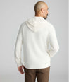 Model is wearing UNTUCKit Waffle-Knit Hoodie Sweater in white. 