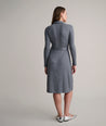 Model is wearing UNTUCKit Blyth dress in solid gray. 