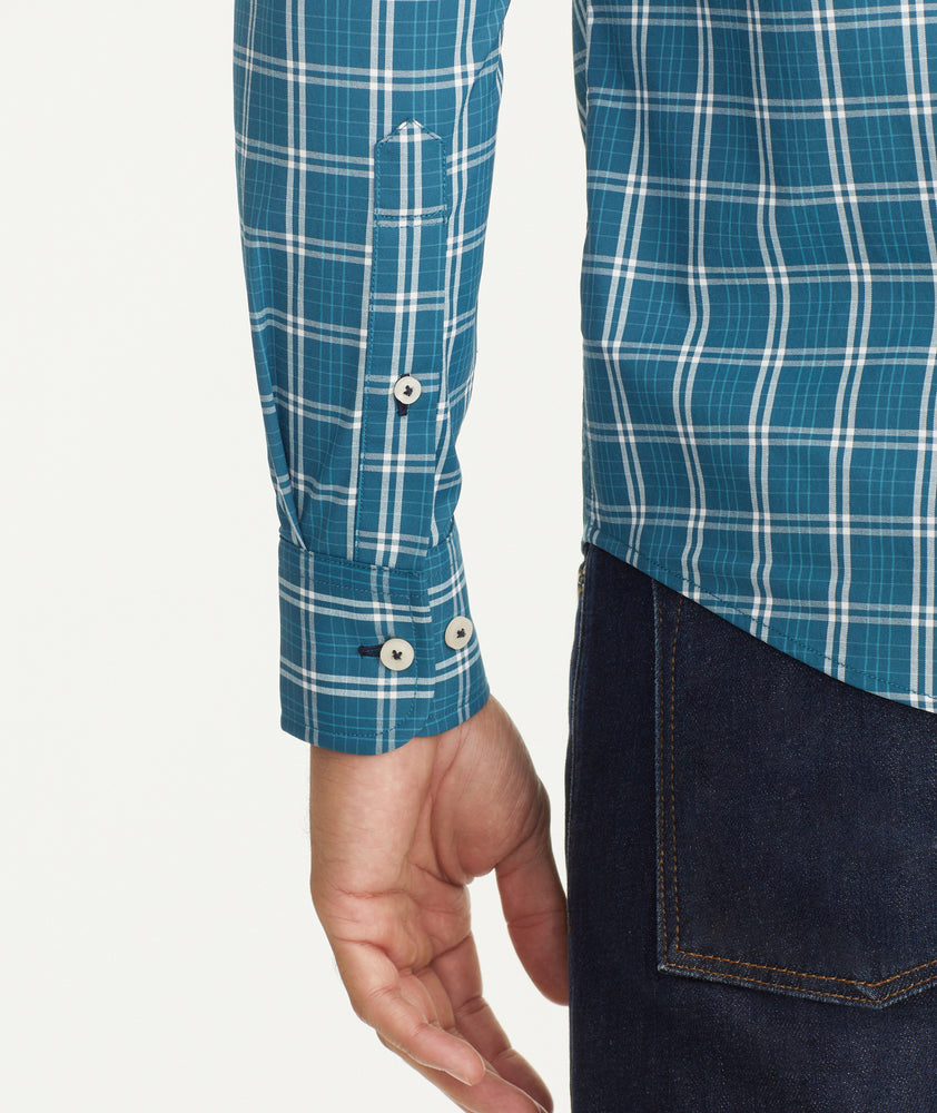 Model is wearing UNTUCKit Wrinkle-Free Performance Bolton Shirt in Teal & White Windowpane Check.
