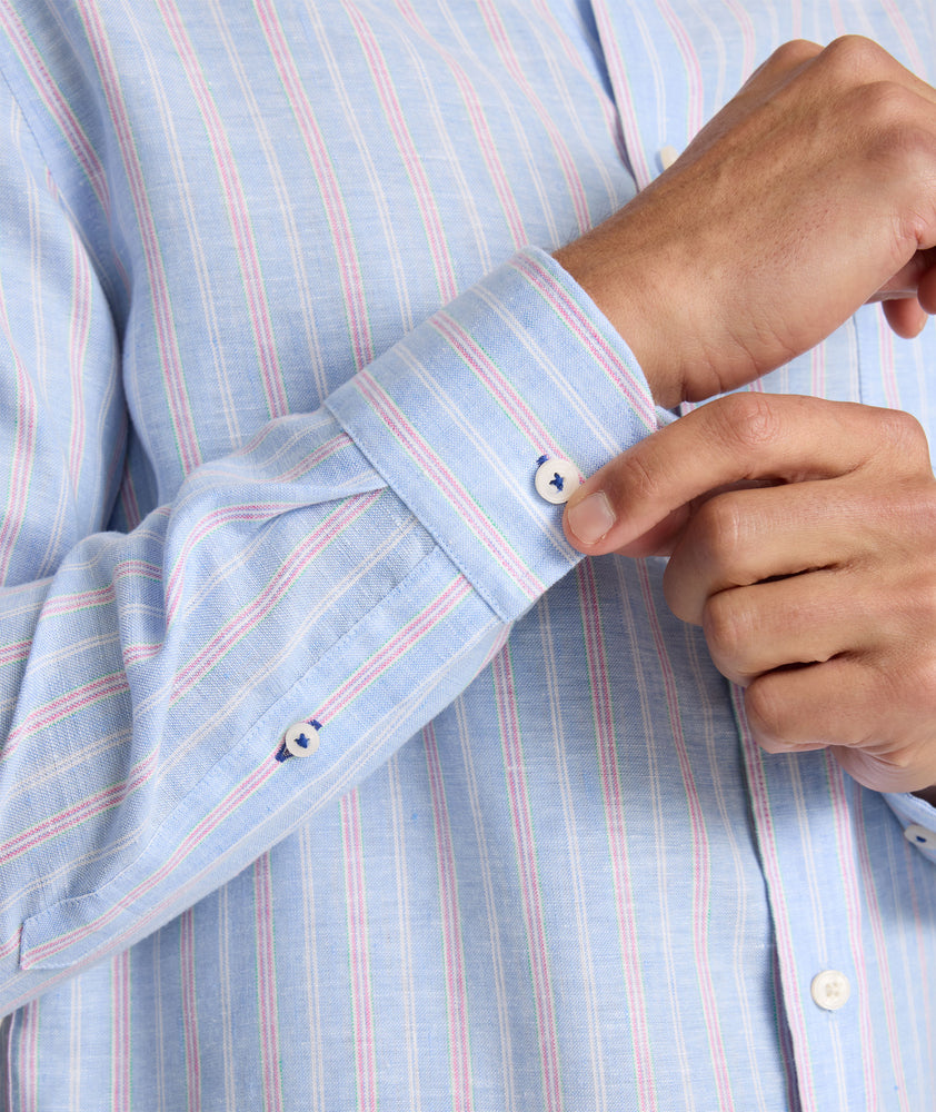 Model is wearing UNTUCKit Boyd  light blue stripe linen shirt.  