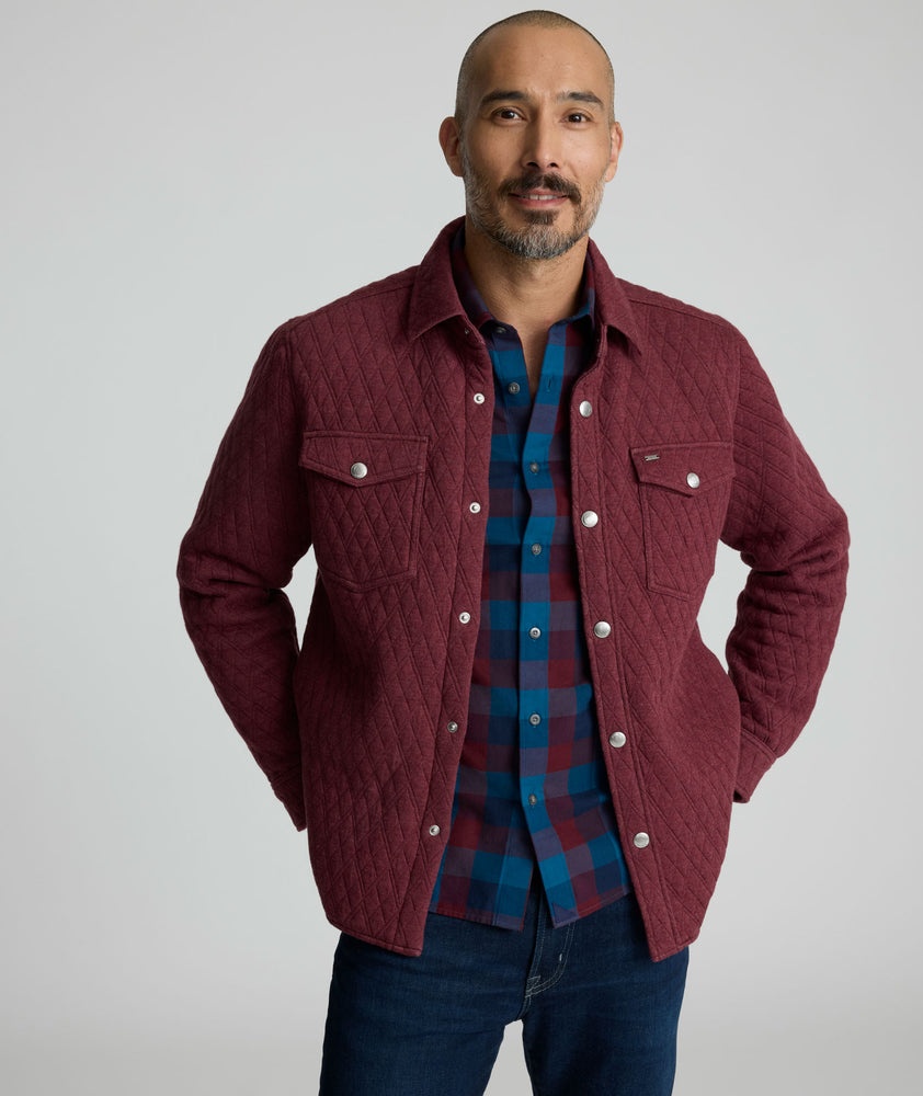 Model is wearing UNTUCKit Braunfield shirt jacket in Maroon. 