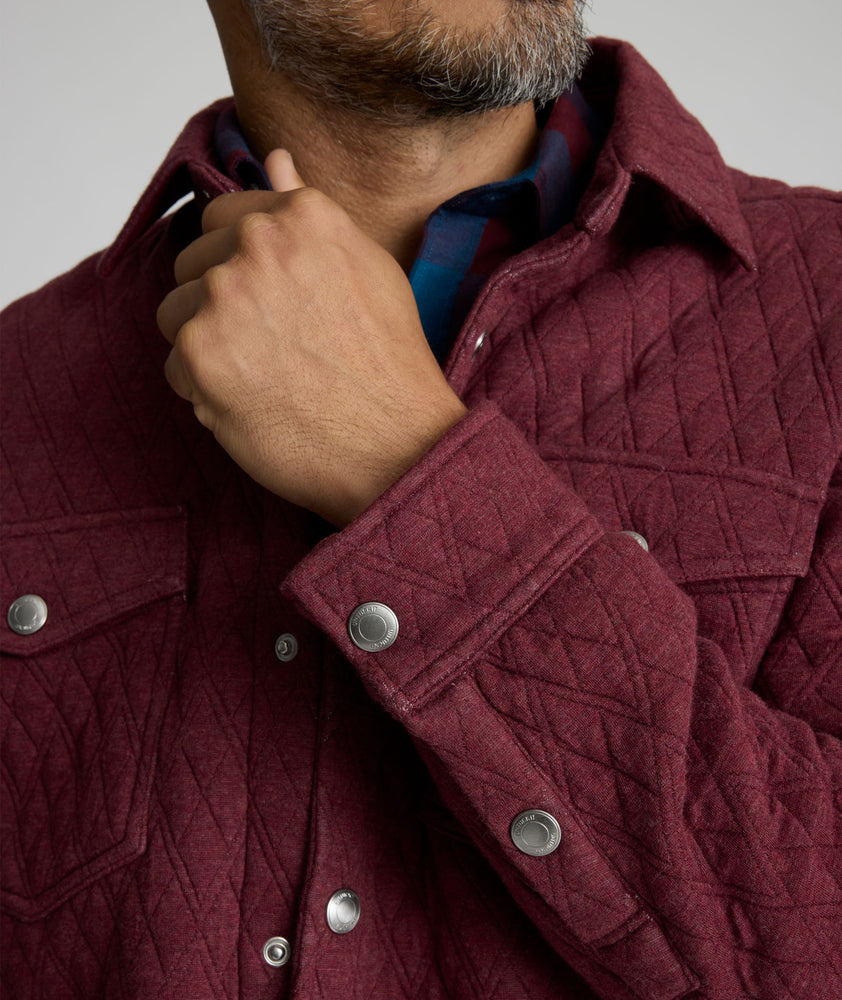 Model is wearing UNTUCKit Braunfield shirt jacket in Maroon. 