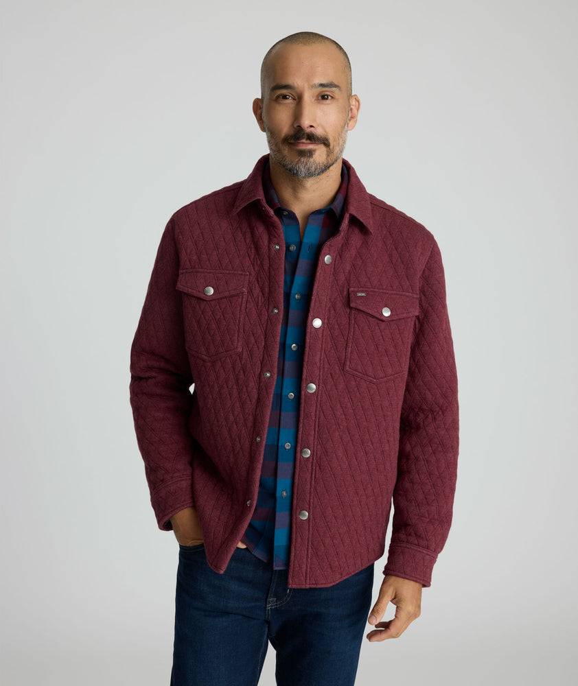 Model is wearing UNTUCKit Braunfield shirt jacket in Maroon. 