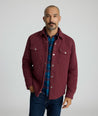 Model is wearing UNTUCKit Braunfield shirt jacket in Maroon. 