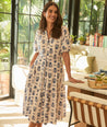 Model is wearing UNTUCKit Brigitte dress in floral white print. 
