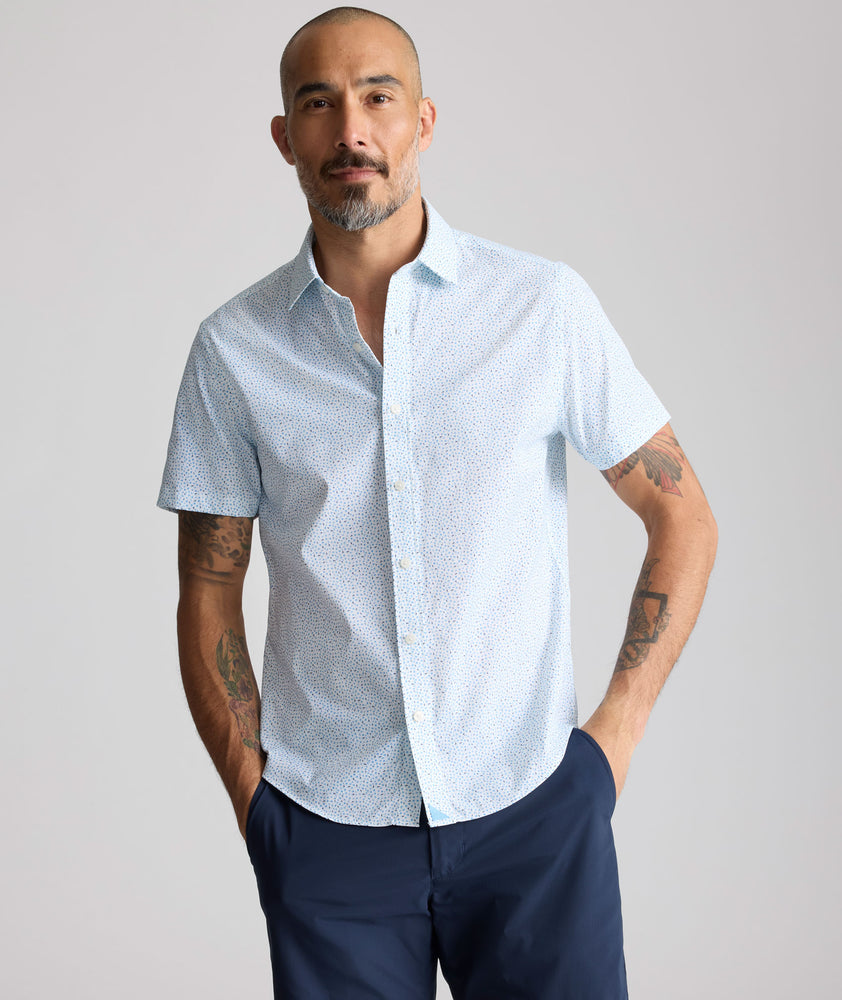 Model is wearing UNTUCKit Performance Short-Sleeve Brookstone Shirt in blue. 