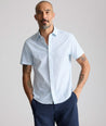 Model is wearing UNTUCKit Performance Short-Sleeve Brookstone Shirt in blue. 