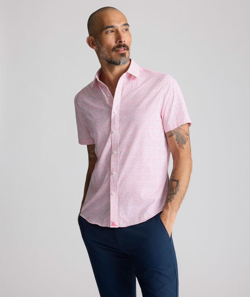 Model is wearing UNTUCKit  Performance Short-Sleeve Brookstone Shirt in pink. 