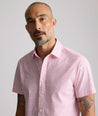 Model is wearing UNTUCKit  Performance Short-Sleeve Brookstone Shirt in pink. 