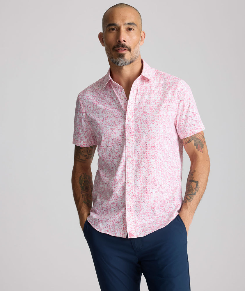 Model is wearing UNTUCKit  Performance Short-Sleeve Brookstone Shirt in pink. 