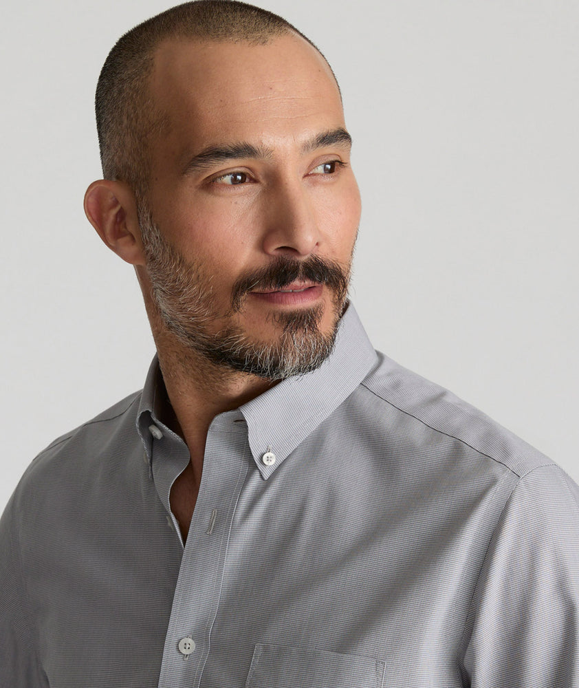 Model is wearing UNTUCKit Cadetto wrinkle-free shirt in castlerock.