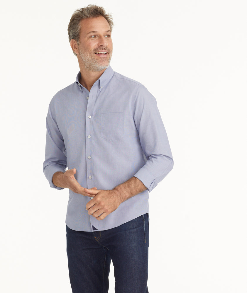 Model is wearing UNTUCKit Wrinkle-Free Cadetto Shirt in Navy.