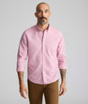 Model is wearing UNTUCKit Cadetto wrinkle-free shirt in rose wine.