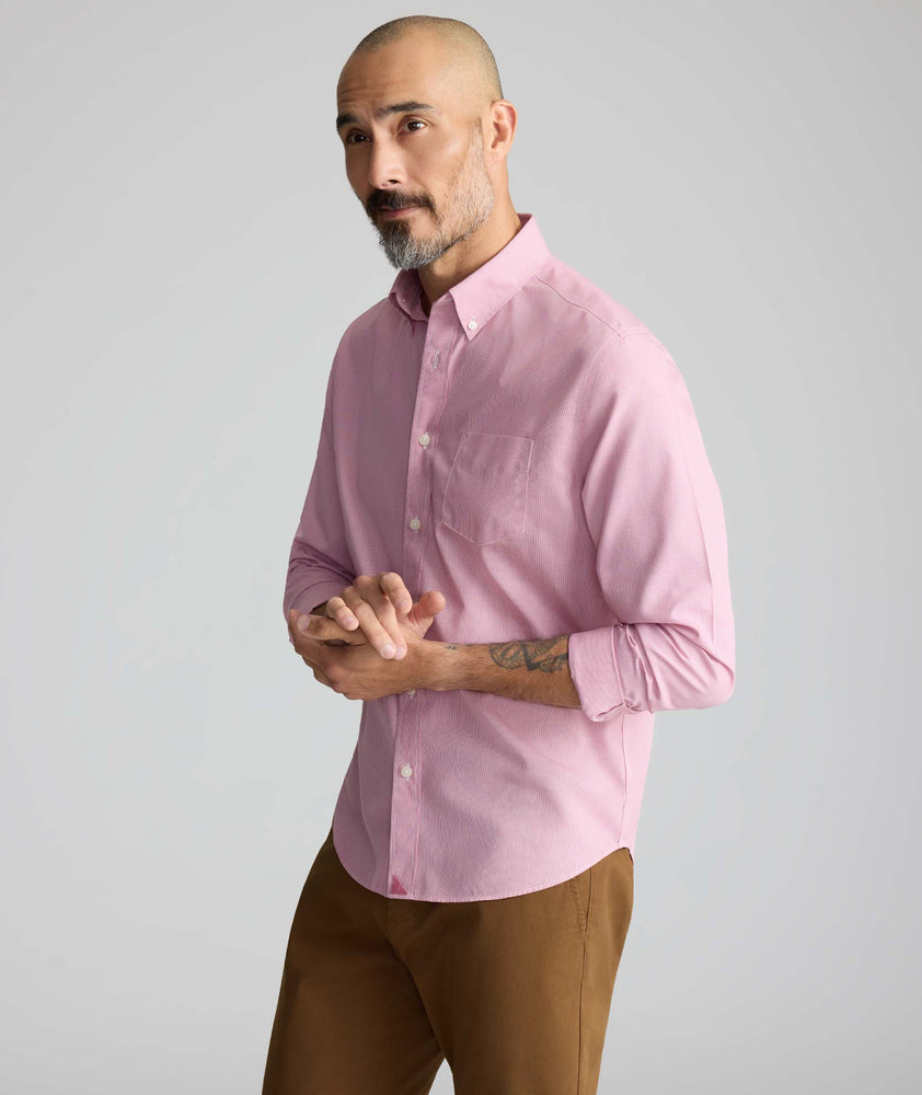 Model is wearing UNTUCKit Cadetto wrinkle-free shirt in rose wine.