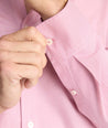 Model is wearing UNTUCKit Cadetto wrinkle-free shirt in rose wine.