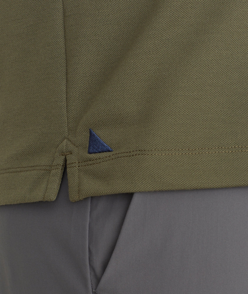 Model is wearing UNTUCKit Ceasar long sleeve polo in ivy green.