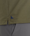 Model is wearing UNTUCKit Ceasar long sleeve polo in ivy green.