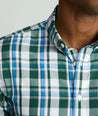 Model is wearing UNTUCKit Caldwell shirt in green large plaid.