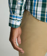 Model is wearing UNTUCKit Caldwell shirt in green large plaid.