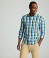 Model is wearing UNTUCKit Caldwell shirt in green large plaid.