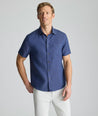 Model wearing an UNTUCKit Navy Wrinkle-Resistant Linen Short Sleeve Cameron Shirt.