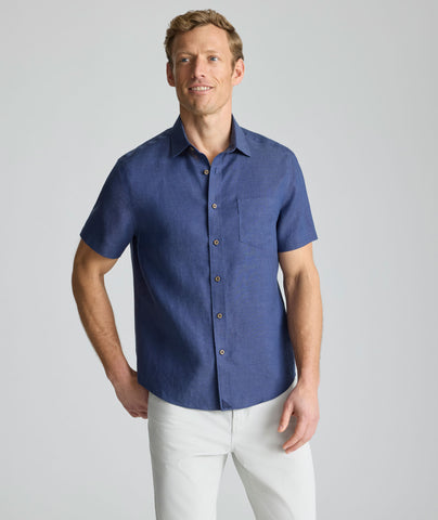 Model wearing an UNTUCKit Navy Wrinkle-Resistant Linen Short Sleeve Cameron Shirt.