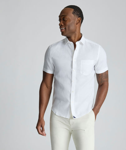 Model wearing an UNTUCKit Bright White Wrinkle-Resistant Linen Short-Sleeve Cameron Shirt.