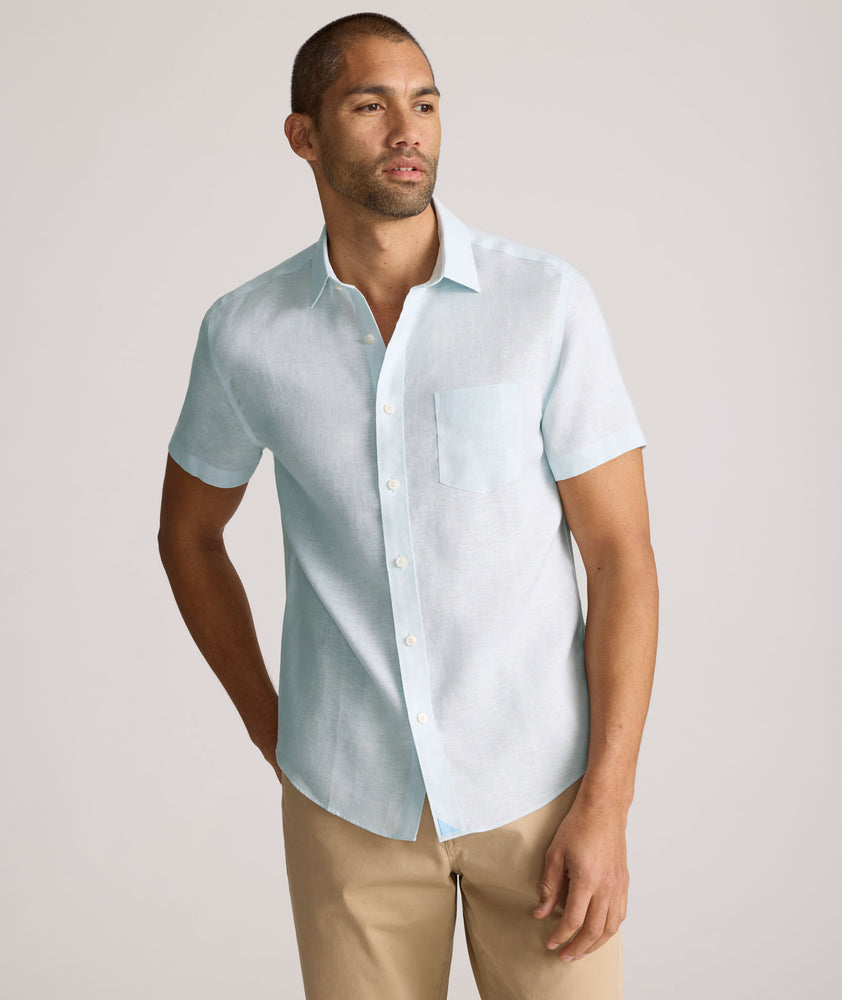 Model is wearing UNTUCKit Cameron sort sleeve shirt in light blue. 