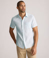 Model is wearing UNTUCKit Cameron sort sleeve shirt in light blue. 