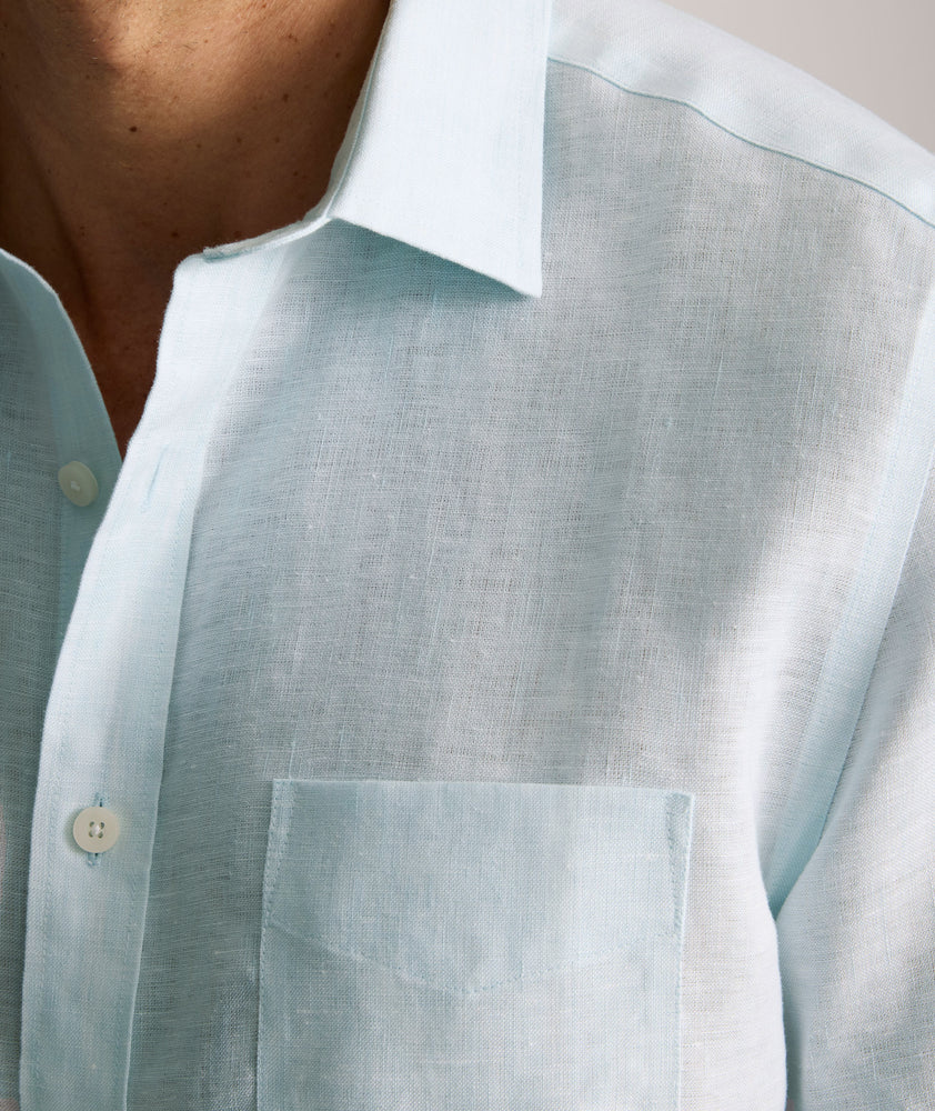 Model is wearing UNTUCKit Cameron sort sleeve shirt in light blue. 
