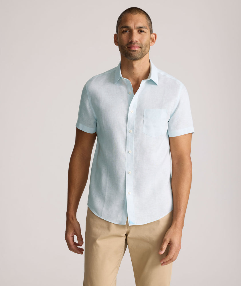 Model is wearing UNTUCKit Cameron sort sleeve shirt in light blue. 