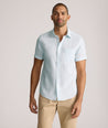 Model is wearing UNTUCKit Cameron sort sleeve shirt in light blue. 