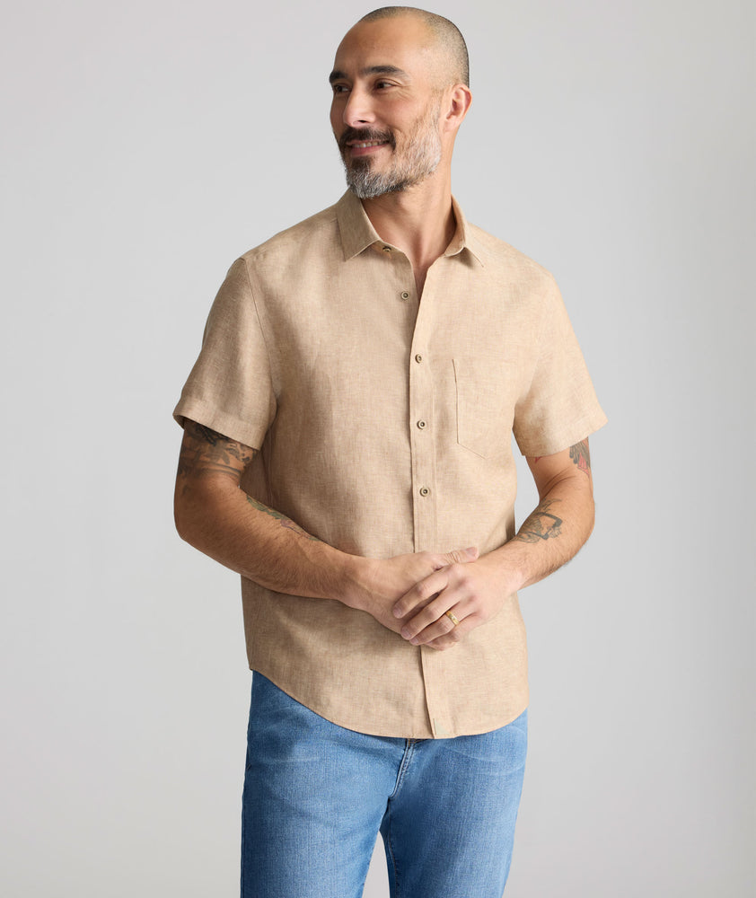Model is wearing UNTUCKit Cameron Shirt in tan. 