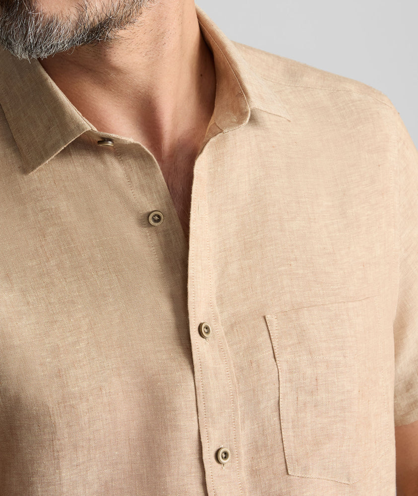 Model is wearing UNTUCKit Cameron Shirt in tan. 