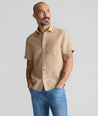 Model is wearing UNTUCKit Cameron Shirt in tan. 